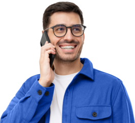 Cheerful young man in blue shirt and glasses, talking on the phone and laughing to friend's joke
