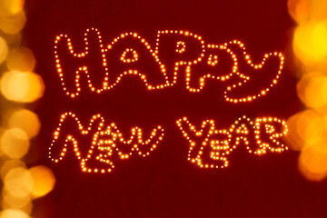 festive greeting card with miracle light on red background and text Happy New Year