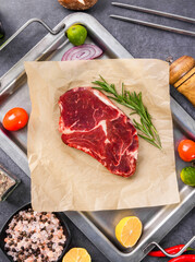 Fresh beef steak on a concrete background