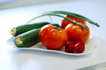 close up.radishes, tomatoes and cucumbers on the table