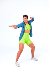 Young woman excercising. Cheerful female fitness Zumba instructor. Young woman excercising. Cheerful female fitness instructor wearing colorful clothing. Positive feeling.