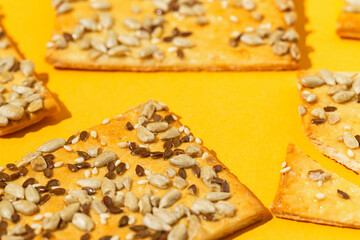 Crunchy cereal cookies closeup on bright orange background. Healthy dessert concept.
