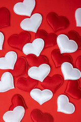 A lot of hearts on a red background. Valentine's Day concept. Vertical image.