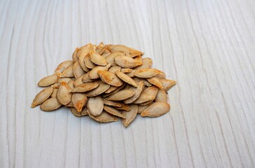 Dry Pumpkin Seed Isolated on White Wooden Background with Copy Spce