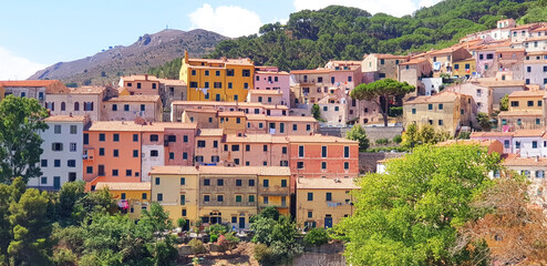 Panorama of city Rio nel Elba with colorful houses and mountains.