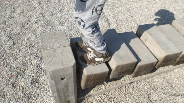 Kid balancing on playground element.