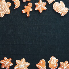 Christmas cookies on Black Craft background. Holiday backdrop. Gingerbread snowflake frame. Top View. Square photo. Copy space