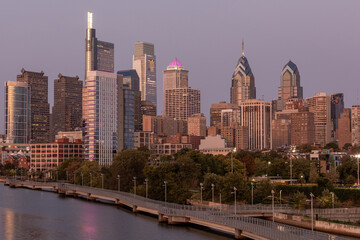 Philadelphia Downtown skyline with the Schuylkill river. Beautiful Sunset Light. Schuylkill River Trail in Background. City skyline glows under the beautiful sunset light. Cityscape. PA, USA.