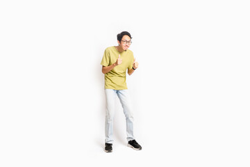 Single skinny young male. The full body of an Asian or Indonesian person. Isolated photo studio with white background.
