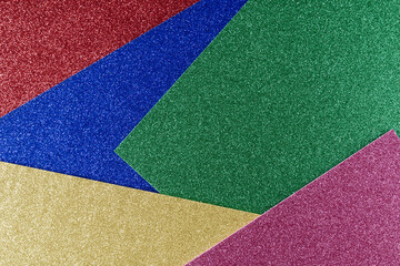 Background of blue,yellow,green and red textured paper in bright colors, geometric pattern.