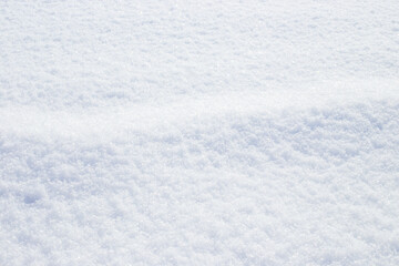 snow background. Snowflakes sparkle on the white surface of the snow