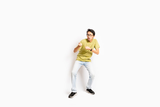 Single skinny young male. The full body of an Asian or Indonesian person. Isolated photo studio with white background.