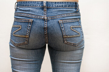 Beautiful female buttocks in tight jeans, close up