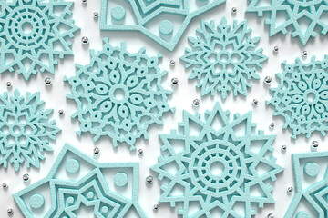 Stylish winter festive background of shimmering blue snowflakes. Christmas and New Year. Volume texture. 3d illustration. 