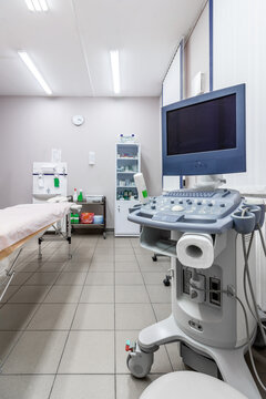 Interior of hospital room with ultrasound machine and bed