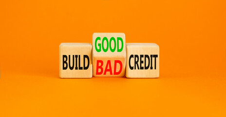 Build good or bad credit symbol. Concept word Build good or bad credit on wooden cubes. Beautiful orange table orange background. Business and build good or bad credit concept. Copy space.