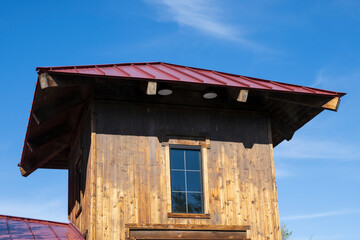 A red metal roof on a wooden tower