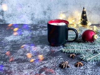 Hot chocolate with bizet pads on a table decorated for Christmas and New Year on
a dark gray background. Aniseed stars. A postcard with copy space