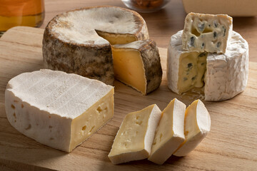 French cheese board with a variation of cheese, Tommette de Montagne, Bresse Bleu and Le coq de Bruyere close up  