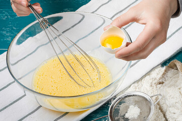 Kneading the dough with a whisk. Dough for pancakes. Liquid dough