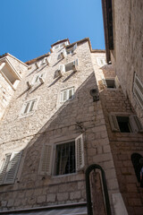 Fototapeta na wymiar Old medieval wall with wooden window shutters in Split in Croatia