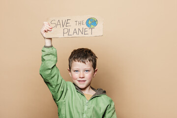 Boy with Save the Planet poster