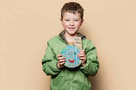 Boy with handmade Earth during environmental campaign