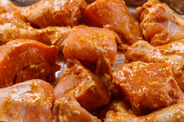 chicken parts in soy sauce and spicy spices marinated on foil.