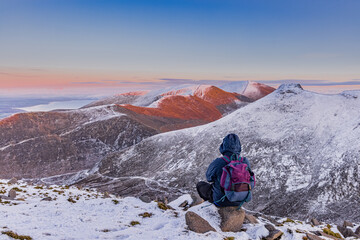 Naklejka premium Sunset cloud inversion from Slieve Meelmore in the snowy Mourne Mountains, County Down, Northern Ireland