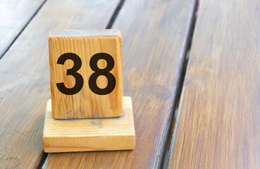 Wooden priority number 38 on a plank tab