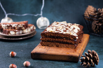 Traditional polish dessert piernik, pryanik or sponge cake with spices and honey. Rectangular piece of brown cocoa tart, gingerbread or layer biscuit. Polish christmas dessert