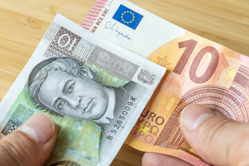 Money in hand, croatian kuna and euro, the concept of Croatians joining the euro zone, exchanging...