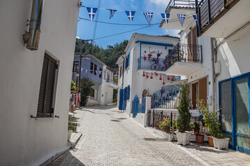 Fototapeta na wymiar Typical narrow Greek streets and architecture with country side houses style in small village named Potamia at Thasos island, South-East from Thessaloniki 