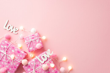 Saint Valentine's Day concept. Top view photo of present boxes light bulb garland inscriptions love and fluffy pompons on isolated pastel pink background with copyspace