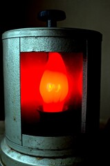 A lit red lamp behind the glass
