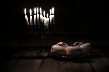 Keuken spatwand met foto hanukkah candle on wooden background with donuts © reznik_val