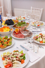 Served for holiday banquet restaurant table with dishes, snack, cutlery, wine and water glasses.