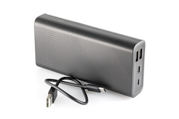 Fototapeta premium Additional self-contained external battery for charging mobile and other device. Power bank isolated on white background. Stylish charger (rechargeable battery). Full depth of field.