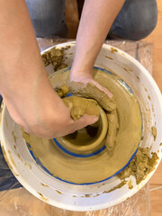 Female hands working with loam, close up. Profession pottery concept.