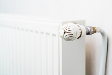 Faucet or temperature regulator on the radiator of the heating system, selective focus. Background