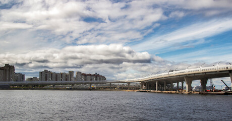 Fototapeta na wymiar City view and road bridge under blue cloudy sky