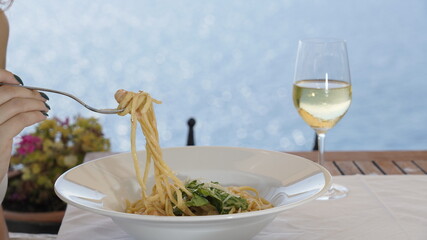 Pasta and white wine at the seaside restaurant