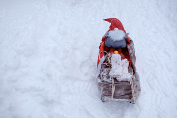 Santa Claus gnome on sleigh with tangerine and mittens Merry Christmas and Happy New Year
