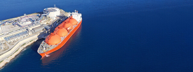 Aerial drone ultra wide panoramic photo of LNG (Liquified Natural Gas) tanker anchored in small gas...