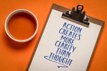 action creates more clarity than thought - inspirational reminder on a clipboard, productivity and personal development concept