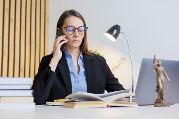 female lawyer in strict suit works in office or court, checks clients' contracts, talks on phone....