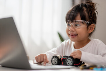 Asia students learn at home in coding robot cars and electronic board cables in STEM, STEAM, mathematics engineering science technology computer code in robotics for kids concept.