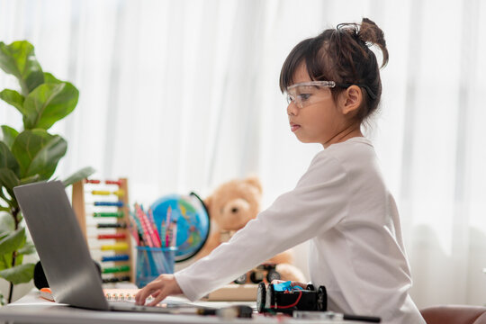 Asia students learn at home in coding robot cars and electronic board cables in STEM, STEAM, mathematics engineering science technology computer code in robotics for kids concept.