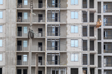 Multistory residential white brick building facade construction site, outdoor architecture details pattern
