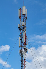 Mobile telecommunication cell tower with antennas and electronic equipments. Cellular transmitter on blue sky